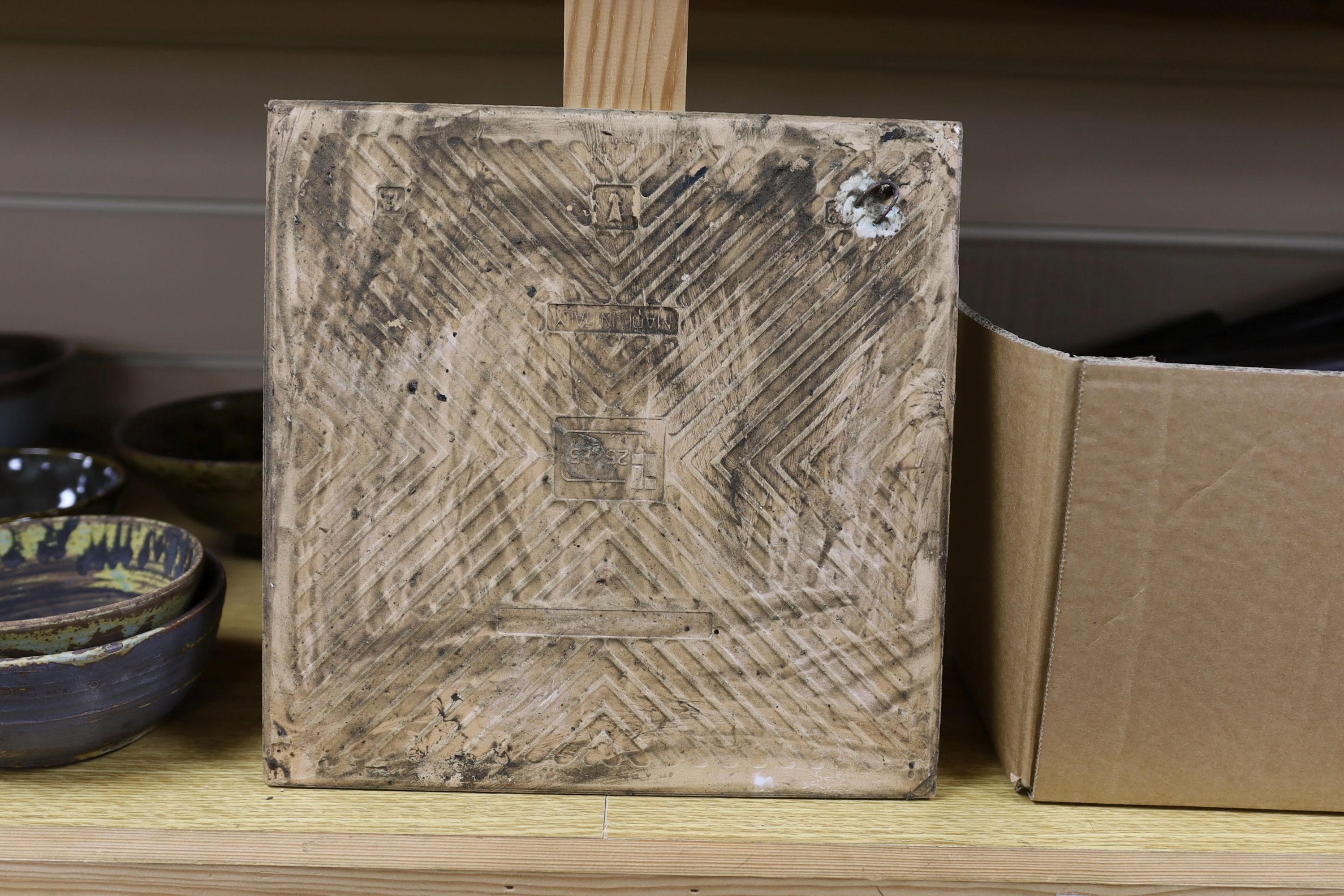 A large pottery figural tile together with a collection of studio pottery bowls
